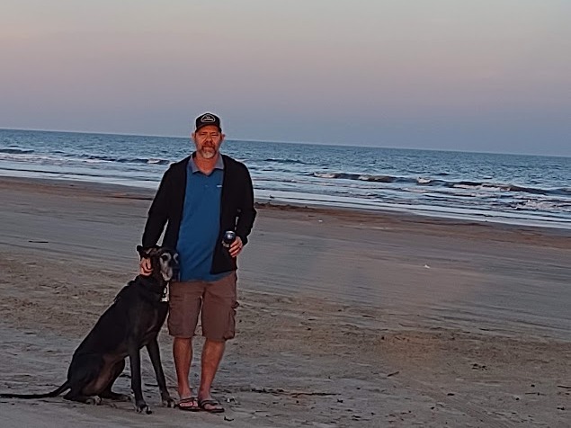 Randy standing Thunder on the beach beneath the moon