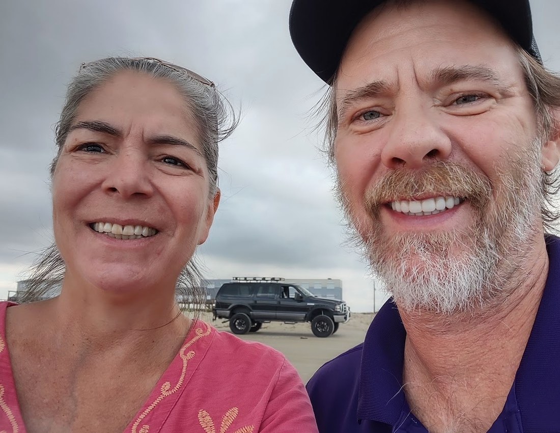 Randy and Lisa smiling together at the beach